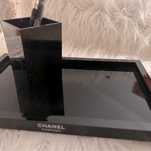 A black lacquer plastic tray and cup holder.This is Chanel fragrances .